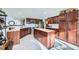 Kitchen with wood cabinets, stainless steel appliances, and an island at 11122 W Cooper Dr, Littleton, CO 80127