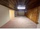 Spacious unfinished basement with wood-paneled walls and neutral carpeting at 12226 E Ohio Ave, Aurora, CO 80012