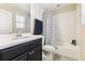 Clean bathroom with a shower/tub combo and dark vanity at 8551 Orchard Way, Arvada, CO 80007