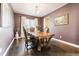 Elegant dining room featuring hardwood floors and a rich color palette at 8551 Orchard Way, Arvada, CO 80007