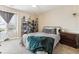 Cozy bedroom with a bookshelf and window seat at 8551 Orchard Way, Arvada, CO 80007