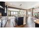Modern kitchen with island, stainless steel appliances, and hardwood floors at 8551 Orchard Way, Arvada, CO 80007