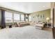 Bright living room featuring a large sectional sofa and neutral color scheme at 8551 Orchard Way, Arvada, CO 80007