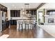 Modern kitchen with breakfast bar, stainless steel appliances, and dark cabinetry at 8551 Orchard Way, Arvada, CO 80007
