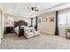Spacious primary bedroom with carpeted floors and large windows at 8551 Orchard Way, Arvada, CO 80007
