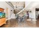 Open concept dining area with hardwood floors and staircase at 8551 Orchard Way, Arvada, CO 80007