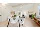 Modern dining area with glass top table and white chairs at 2735 Denver Ave, Longmont, CO 80503