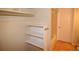 Bathroom closet with built-in shelving next to a full bathroom at 7369 S Gore Range Rd # 103, Littleton, CO 80127