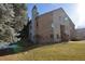 Attractive condo building with stone accents and a well-maintained lawn at 7369 S Gore Range Rd # 103, Littleton, CO 80127