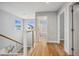 Bright hallway with hardwood floors and access to bedrooms and bath at 779 Kohlor Dr, Lafayette, CO 80026