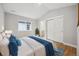 Bedroom with wood floors, ensuite bathroom, and a window at 779 Kohlor Dr, Lafayette, CO 80026