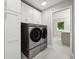 Laundry room with modern washer, dryer, and cabinets at 779 Kohlor Dr, Lafayette, CO 80026