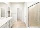 Modern bathroom with double sinks, a shower, and linen closet at 24088 E Atlantic Pl, Aurora, CO 80018