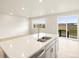 Modern kitchen island with double sink, stainless steel appliances and a view to backyard at 24088 E Atlantic Pl, Aurora, CO 80018