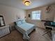 Bright bedroom with striped bedding, window, and built-in desk at 20175 Edinborough Pl, Parker, CO 80138