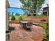 Relaxing stone patio with seating area and built-in fire pit at 20175 Edinborough Pl, Parker, CO 80138