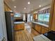 Open kitchen with stainless steel appliances and view into the living room at 20175 Edinborough Pl, Parker, CO 80138