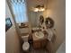 Clean bathroom with single sink vanity, toilet, and decorative wreath at 20175 Edinborough Pl, Parker, CO 80138