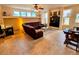 Open living room with sectional sofa, coffee table, and built-in entertainment center at 20175 Edinborough Pl, Parker, CO 80138