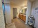 Main bathroom with double vanity, shower, and separate toilet area at 20175 Edinborough Pl, Parker, CO 80138