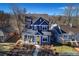 Stunning aerial view of a charming two-story home with a yellow door and landscaped yard at 6067 S Hill St, Littleton, CO 80120