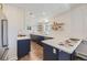 Modern kitchen with blue cabinets, white countertops, and stainless steel appliances at 1288 S Emerson St, Denver, CO 80210