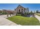 Craftsman style home with a charming front porch and landscaped yard at 8741 S Ukraine Ct, Aurora, CO 80016