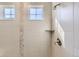 Shower with tile surround, window and corner shelf at 8741 S Ukraine Ct, Aurora, CO 80016