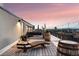 Private rooftop deck with city views and lounge chair at 669 N Washington St # 901, Denver, CO 80203