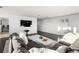 Open living area with sectional sofa, coffee table, and a large flat screen TV at 669 N Washington St # 901, Denver, CO 80203