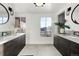 Modern bathroom with double vanity, large mirror, and city view at 669 N Washington St # 901, Denver, CO 80203