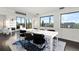 Modern dining room with a large table and chairs, and city views at 669 N Washington St # 901, Denver, CO 80203