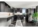 Modern kitchen with dark cabinetry, white countertops and stainless steel appliances at 669 N Washington St # 901, Denver, CO 80203
