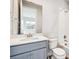Bathroom with gray vanity, white countertop, and tiled shower at 1737 Marlowe E Cir, Erie, CO 80516