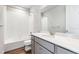 Gray bathroom vanity, white countertop, and a bathtub at 1737 Marlowe E Cir, Erie, CO 80516