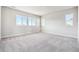 Large bedroom with plush gray carpeting and windows with neighborhood views at 1737 Marlowe E Cir, Erie, CO 80516