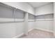 Spacious walk-in closet with built-in shelving and plush carpeting at 1737 Marlowe E Cir, Erie, CO 80516