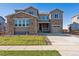 Two-story house with stone accents and a three-car garage at 1737 Marlowe E Cir, Erie, CO 80516