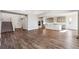 Spacious great room with wood floors, a staircase, and kitchen access at 1737 Marlowe E Cir, Erie, CO 80516
