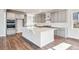 Kitchen with large island, gray shaker cabinets, and stainless steel appliances at 1737 Marlowe E Cir, Erie, CO 80516