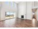 Living room with fireplace, sliding glass doors, and high ceilings at 1737 Marlowe E Cir, Erie, CO 80516