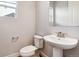 Half bathroom with pedestal sink and wood-style flooring at 1737 Marlowe E Cir, Erie, CO 80516