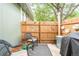 Small, private patio with seating and a grill at 10001 E Evans Ave # 74B, Aurora, CO 80247