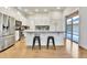 Modern kitchen with island, stainless steel appliances, and white cabinetry at 9045 E 58Th Dr, Denver, CO 80238