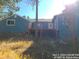 Back exterior view of the home showcasing a deck and landscaping at 11967 W Ranch Elsie Rd, Golden, CO 80403