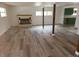 Bright living room features a fireplace and wood-look flooring at 11967 W Ranch Elsie Rd, Golden, CO 80403