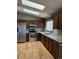Kitchen with wood cabinets, stainless steel appliances, and granite countertops at 18269 E Hampden Pl, Aurora, CO 80013