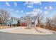 Two-story house with gray siding, red door, and attached garage, viewed from the street at 4050 E 133Rd Cir, Thornton, CO 80241