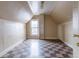 Small attic bedroom with sloped ceilings, checkerboard floors, and a window at 1520 S Acoma St, Denver, CO 80223