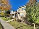 Two-story home with a landscaped yard and a red front door at 183 Mt Bierstadt St, Brighton, CO 80601